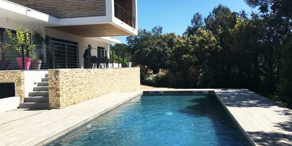 Une belle piscine contemporaine et design avec une maison type californienne